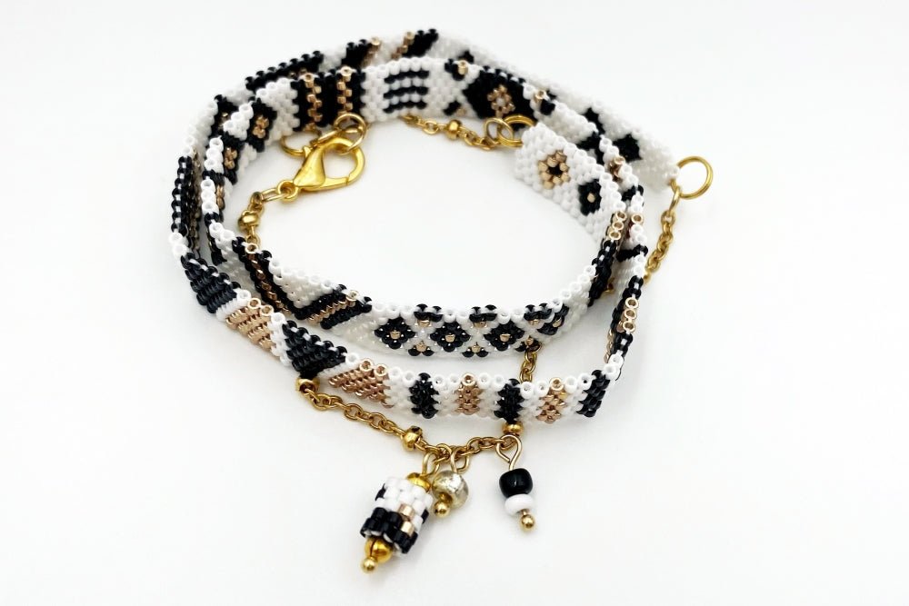 Jewelry set of bracelet and two rings made in geometrical design from black, white and gold Miyuki beads - Ornamentico shop