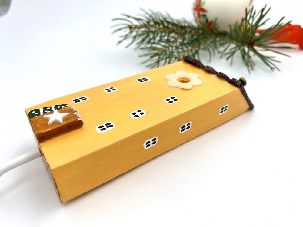 Handmade wooden hook in the shape of a pale orange house decorated for Christmas - Ornamentico shop