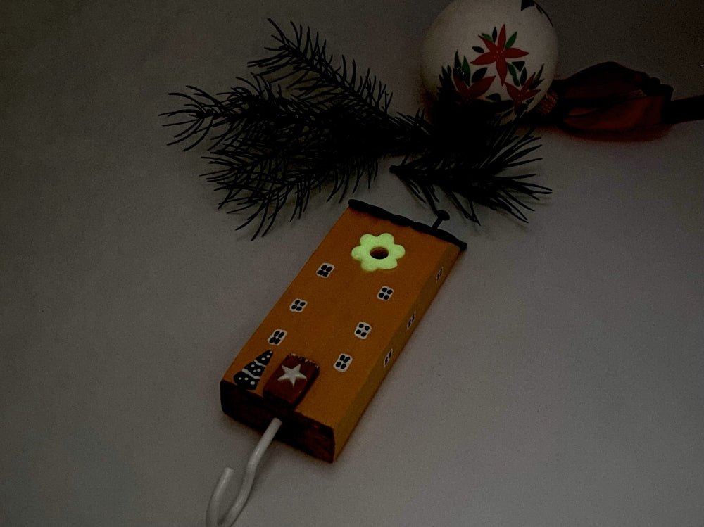 Handmade wooden hook in the shape of a pale orange house decorated for Christmas - Ornamentico shop
