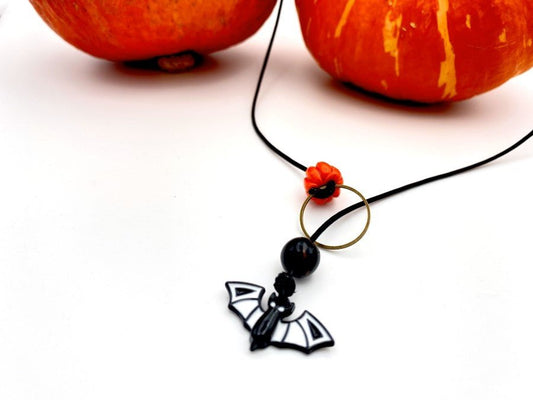 Handmade necklace in lariat style is featuring glass bat and clay pumpkin - Ornamentico shop