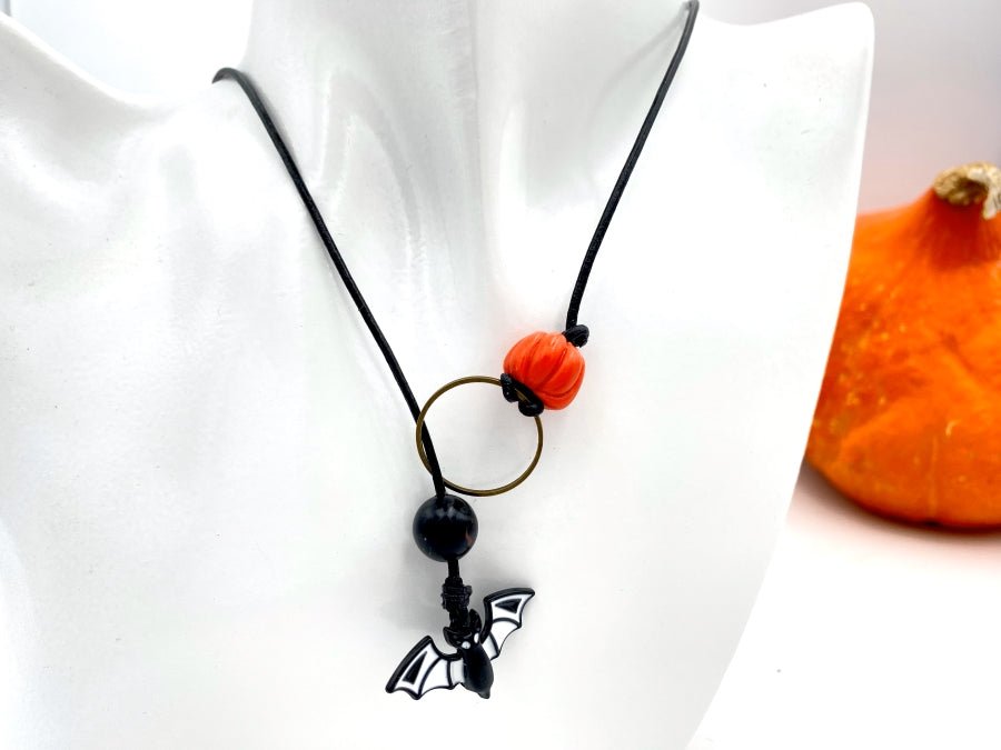 Handmade necklace in lariat style is featuring glass bat and clay pumpkin - Ornamentico shop
