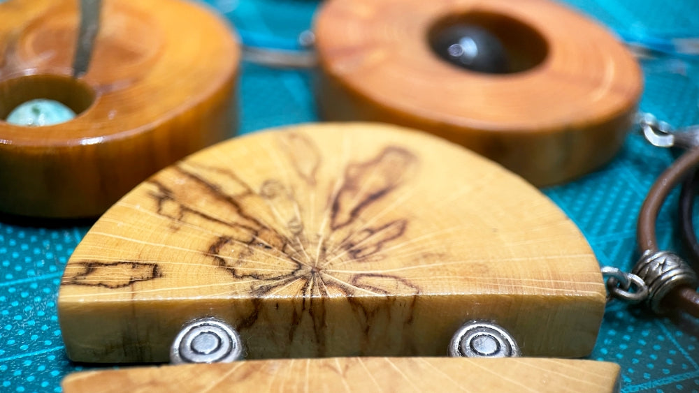 Handmade wooden pendants in a lifestyle setting