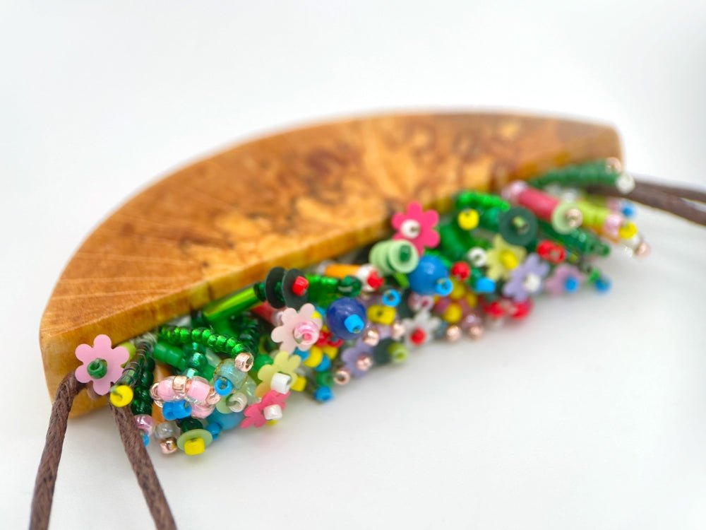 Unique wooden pendant with colorful beaded inlay imitating summer flowerbed