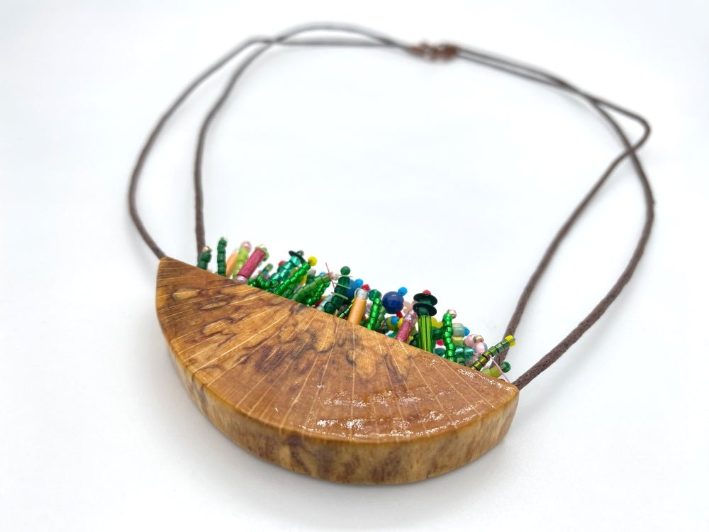 Unique wooden pendant with colorful beaded inlay imitating summer flowerbed