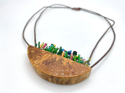 Unique wooden pendant with colorful beaded inlay imitating summer flowerbed