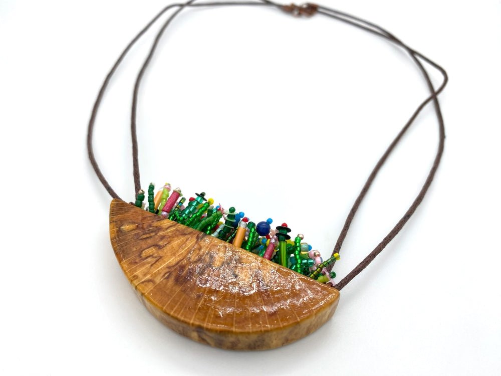 Unique wooden pendant with colorful beaded inlay imitating summer flowerbed