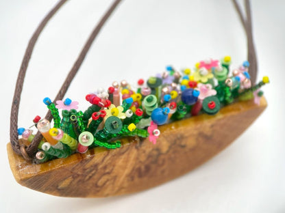 Unique wooden pendant with colorful beaded inlay imitating summer flowerbed