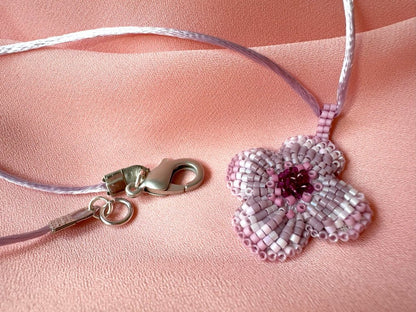 Sculptural floral pendant in soft pink to burgundy tones. Hand-beaded rosette design with silk cord - Ornamentico shop