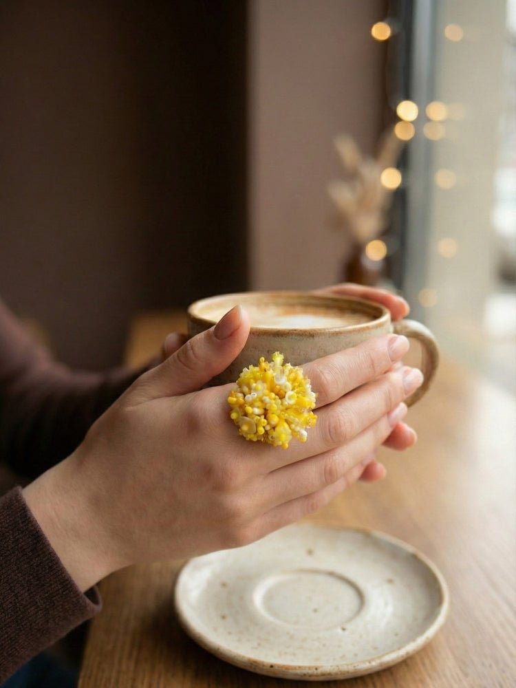 Handmade volume-beaded statement ring with floral design, polymer clay and sequins in yellow hues - Ornamentico shop