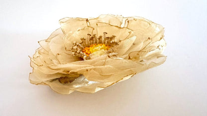 Handmade floral hair barrette crafted from organza fabric and decorated with beaded flower center and stamens