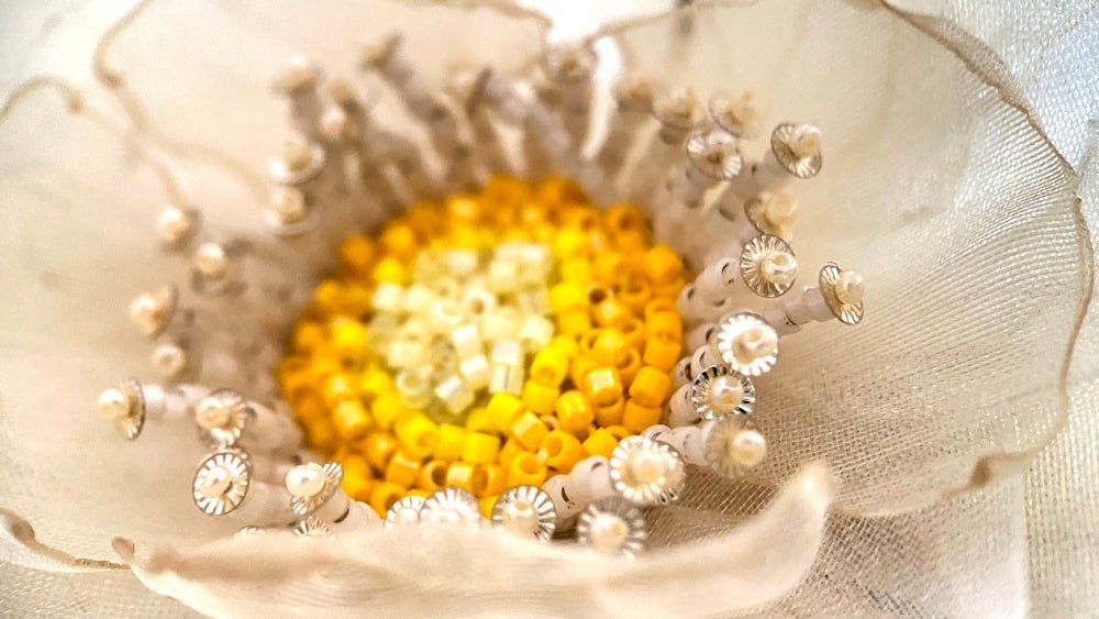 Handmade floral hair barrette crafted from organza fabric and decorated with beaded flower center and stamens