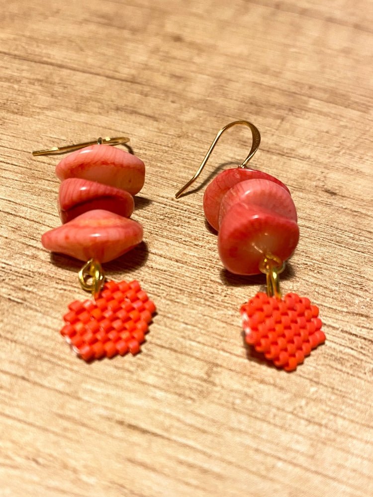 Earrings with coral chips and a small beaded charm in the shape of a heart crafted in peyote stitch technique using Miyuki Delica beads