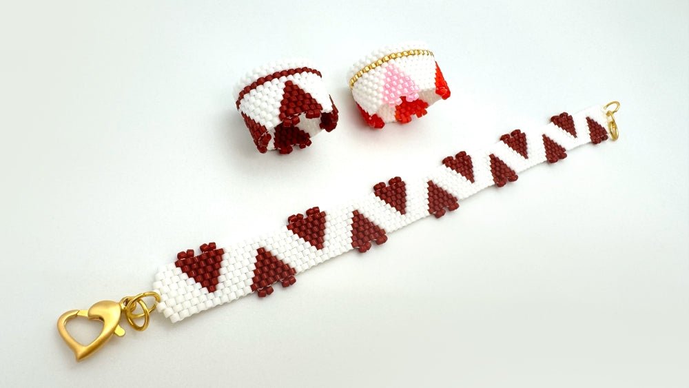 Handmade set of beaded bracelet and two rings ornamented with hearts crafted in peyote stitch technique 