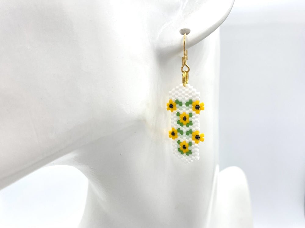 Beaded earrings featuring bright sunflowers crafted in peyote stitch technique with Miyuki Delica beads