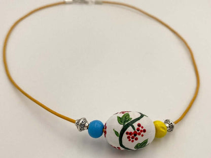 Handmade necklace from hand painted wooden beads crafted in Boho style. The wooden bead is decorated with traditional motif of guelder rose berry. Necklace is decorated with beads in colors of Ukrainian flag - Ornamentico shop