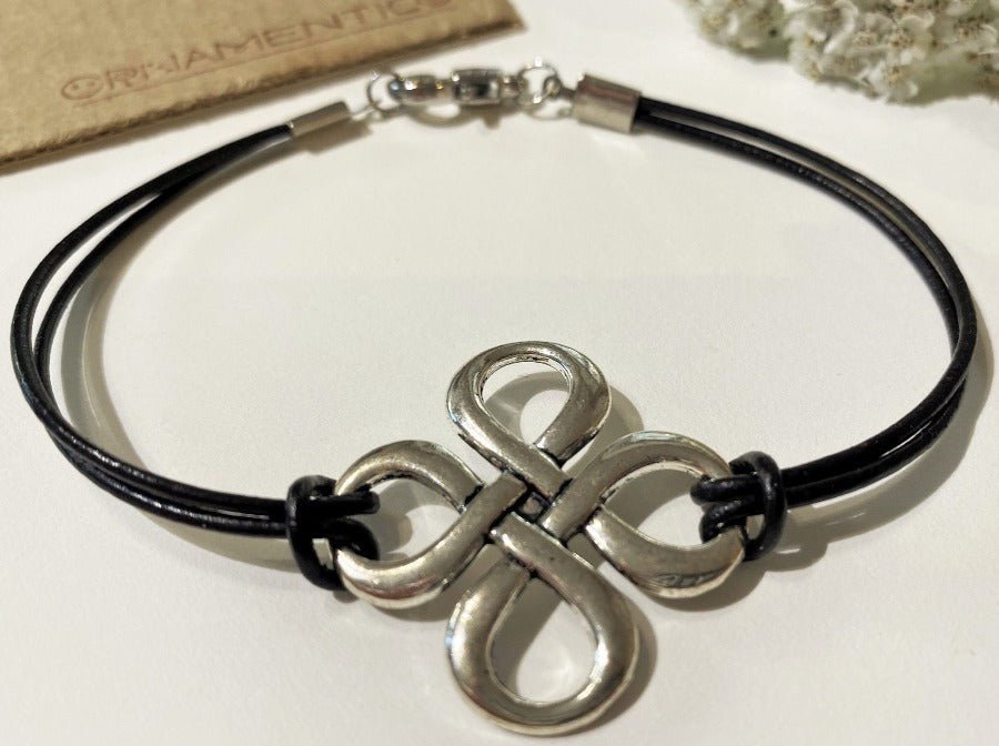 Handmade laconic leather bracelet crafted from black leather decorated with silver-coated eternity sign - Ornamentico shop