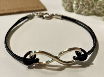 Handmade laconic leather bracelet crafted from black leather decorated with silver-coated infinity sign - Ornamentico shop