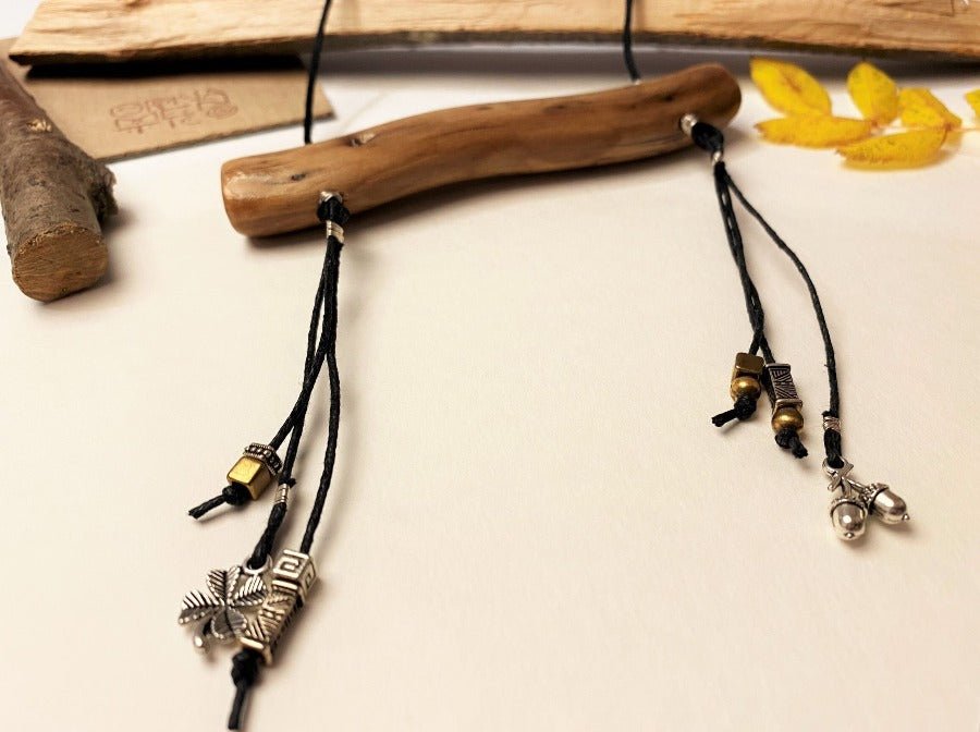 Boho style wooden pendant with silver and bronze charms. Wooden element length: 11 cm.