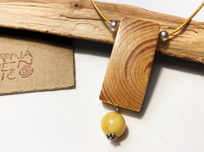 Lacquered wooden pendant with amber bead. Beech wood, Baltic amber beads, silver coated fittings.