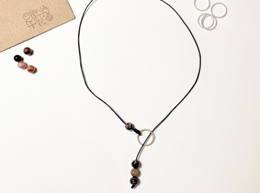 Shop the latest Lariat style necklace crafted from stunning rhodonite beads and genuine leather cord - Ornamentico shop