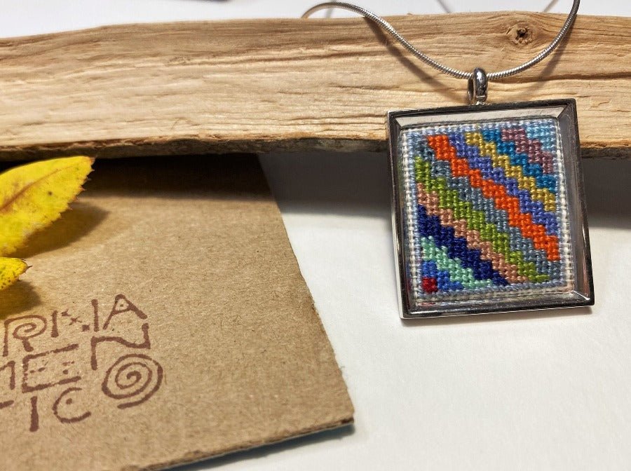 Unique handmade embroidered pendant in a silver frame. Collection "Carpets of Peru"