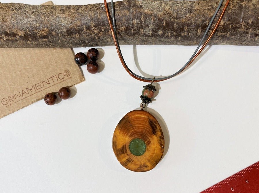 Small handmade wooden pendant crafted from fine polished and lacquered beech wood. Green epoxy resin inlay.