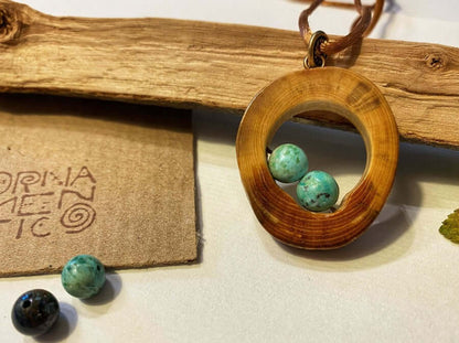 Wooden pendant with two Peruvian turquoise beads. Made of well polished and lacquered beech wood.