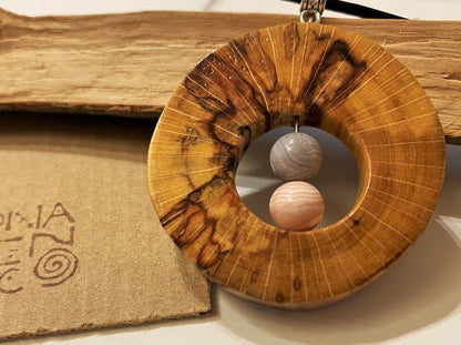 Handmade wooden pendant. Made of polished and lacquered beech wood. Insert of two pink agate stones.