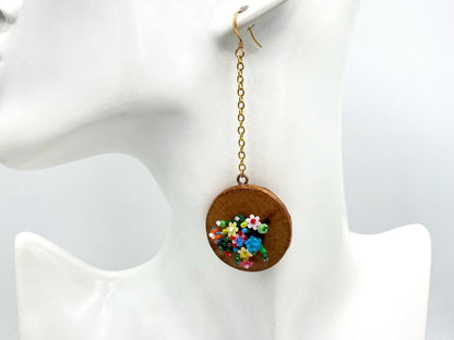 Handmade asymmetric earrings made in sculptural beading technique featuring bright floral design accented by wood - Ornamentico Group