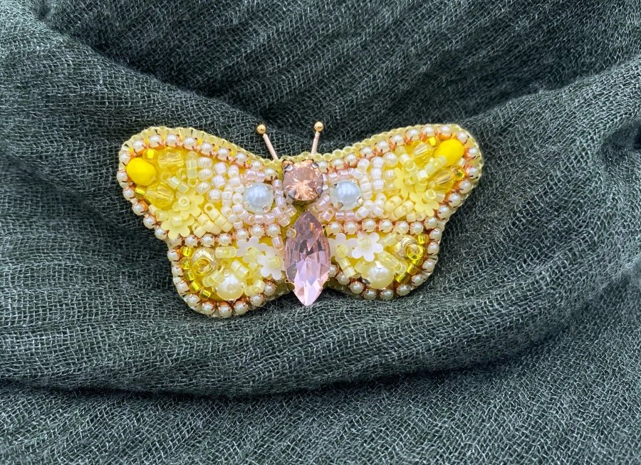 This small butterfly brooch is a handmade piece crafted in light yellow and gold colors - Ornamentico shop