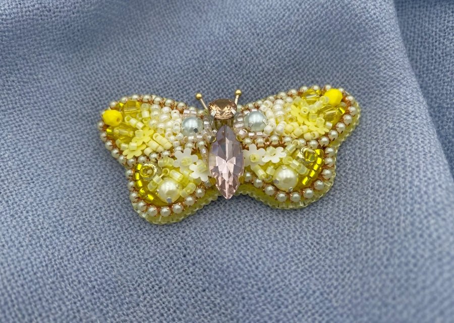 This small butterfly brooch is a handmade piece crafted in light yellow and gold colors - Ornamentico shop