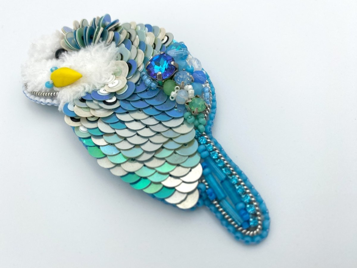 Handmade brooch in the shape of an azure blue wavy parrot made from beads and sequins - Ornamentico shop