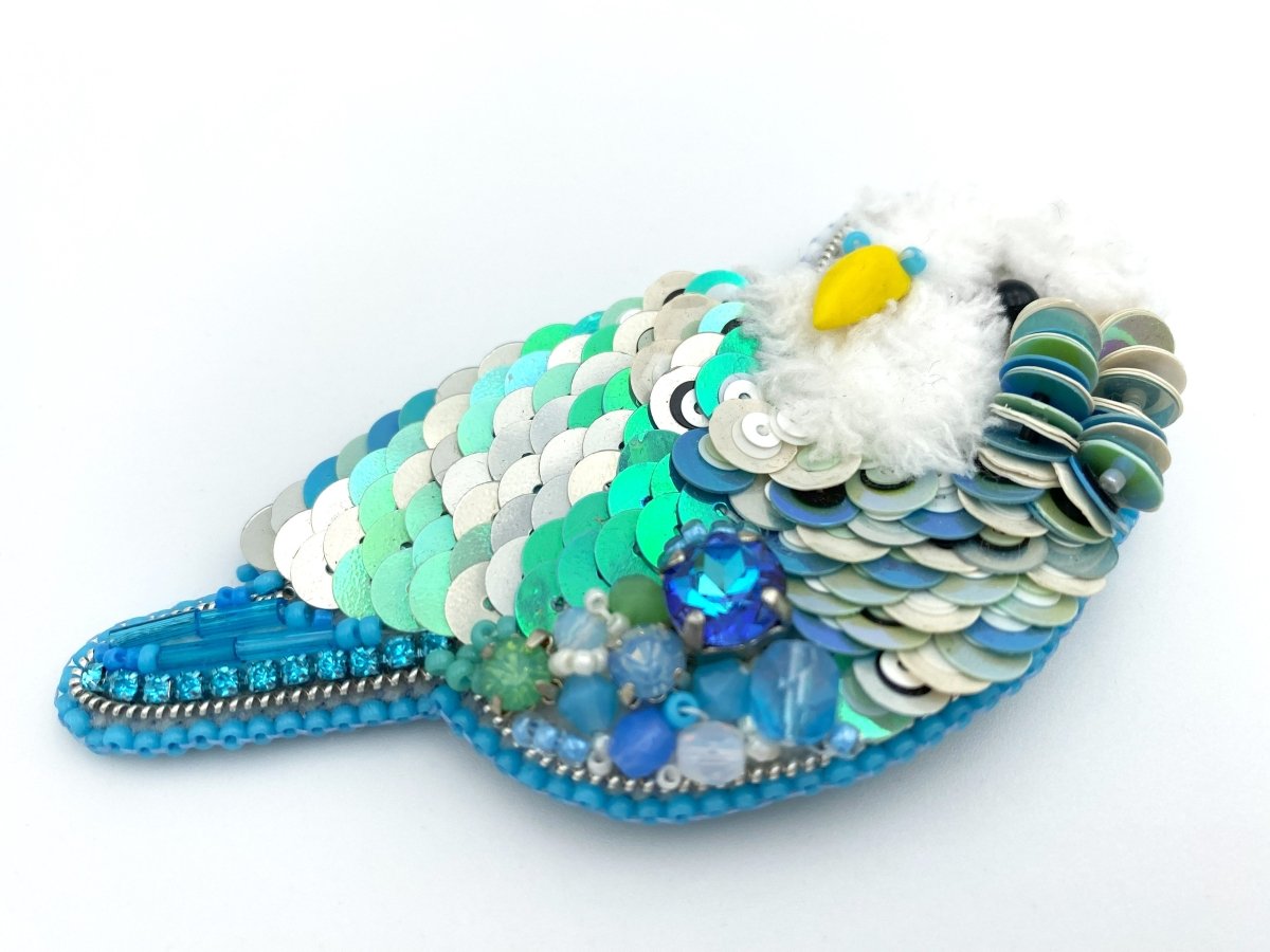Handmade brooch in the shape of an azure blue wavy parrot made from beads and sequins - Ornamentico shop