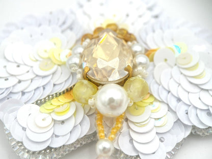 Brooch beaded from sequins, yellow agate, river pearl, rhinestone and beads in the shape of a white orchid - Ornamentico shop
