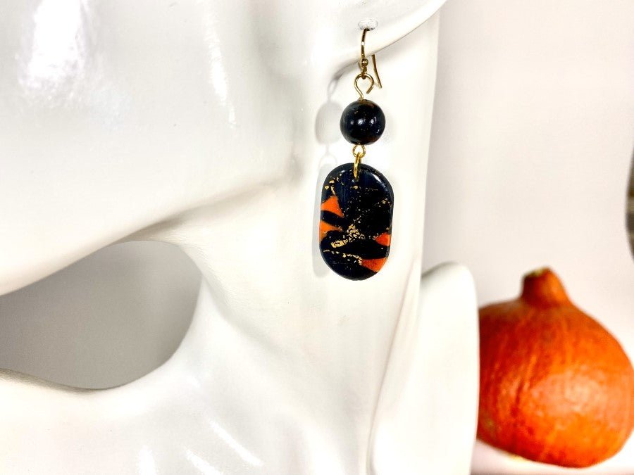 Handmade earrings made from polymer clay in black and orange combination - Ornamentico shop