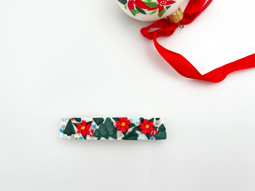 Handmade hair barrette featuring festive ornament of spruce trees, poinsettia flowers and snowflakes - Ornamentico shop