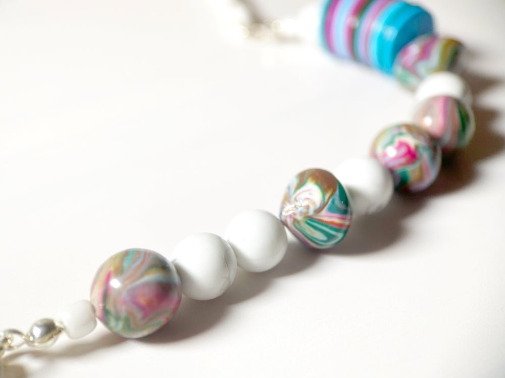 Handmade necklace crafted in traditional winter colors of white, blue, red and green from clay beads - Ornamentico shop