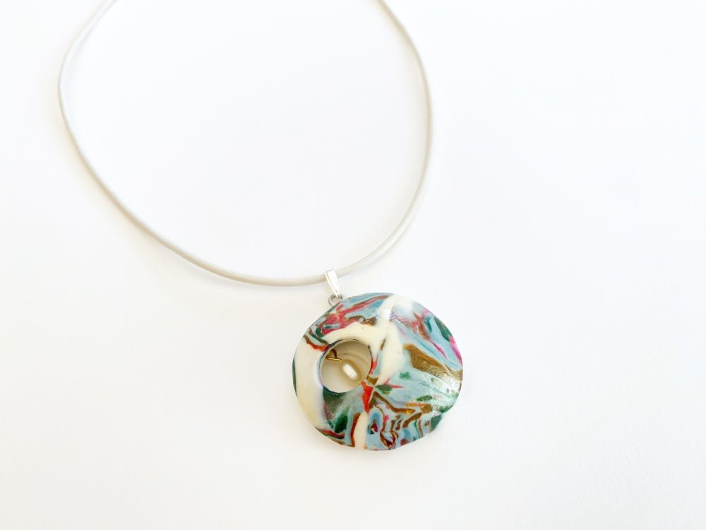 Unique pendant crafted from custom polymer clay marble mix featuring curved front and a small pearl inside - Ornamentico shop