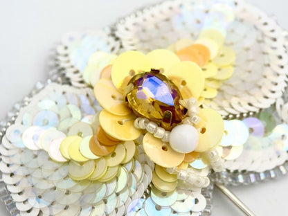 Handmade pin brooch made from rhinestone, sequins and beads in the shape of a small white orchid - Ornamentico shop