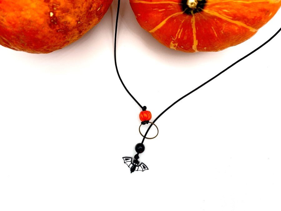 Handmade necklace in lariat style is featuring glass bat and clay pumpkin - Ornamentico shop