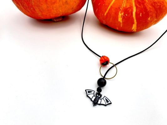 Handmade necklace in lariat style is featuring glass bat and clay pumpkin - Ornamentico shop